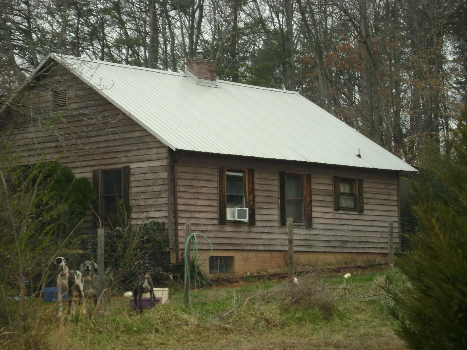 White metal roof on an old wood sided farmhouse, from a Metal Roof Installation job in Clarkrange